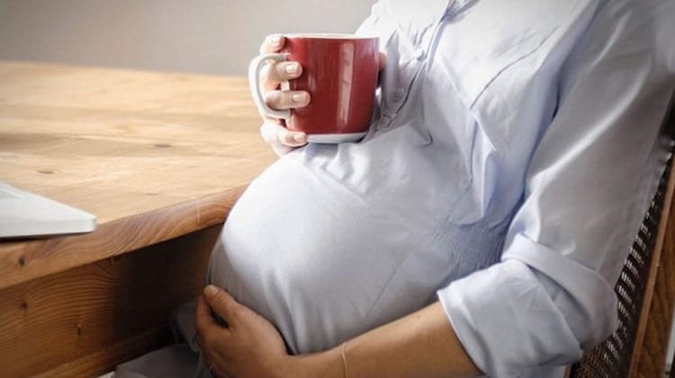 Pregnant Woman Holding Coffee