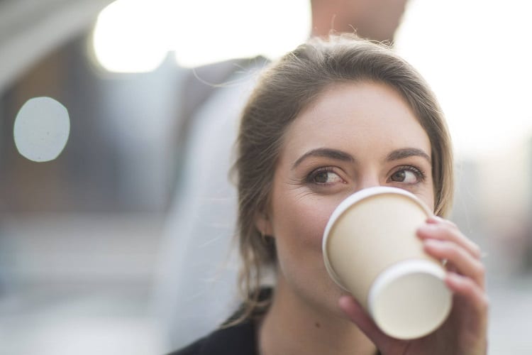 Young Woman Drinking Coffee To Go